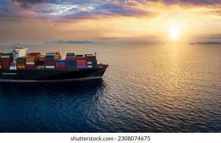 The bow of a large, industrial container cargo ship on open sea sailing into a sunset - Shutterstock ID 2308074675