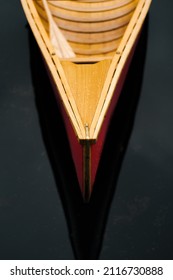 Bow (nose) Of A Beautiful Wooden Canoe Boat On The Water. Front Part A Boat Floating On Dark Water, No People