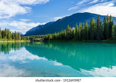 Bow River Trail in summer time. Sulphur Mountain Range in the background. Beautiful nature scenery in Banff National Park, Canadian Rockies, Alberta, Canada. - Shutterstock ID 1912693987