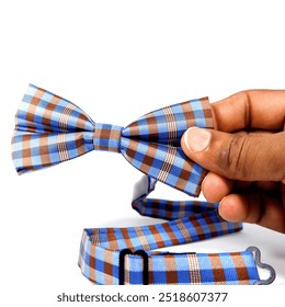 Bow tie holding hand on white background close-up view macro photography  - Powered by Shutterstock