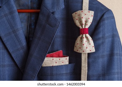 Bow ties and pocket square with embroidery in the breast pocket of a man's blue suit. Wedding accessories. Lutsk, Ukraine - Powered by Shutterstock