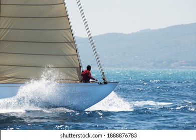 Bow Of Vintage Sailboat Splits Waves In The Wind