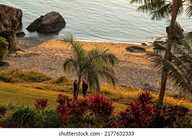 Bowen, Queensland, Australia - June 2022: A Couple Talking On A Small Beach At Sunset