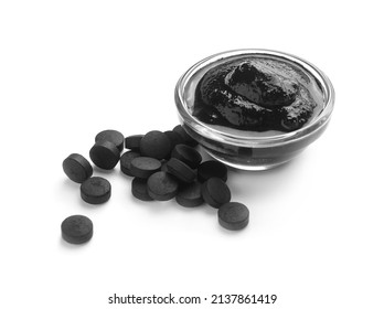 Bowl Of Activated Carbon Mask And Pills On White Background