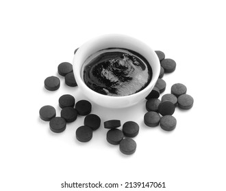 Bowl Of Activated Carbon Mask And Pills On White Background