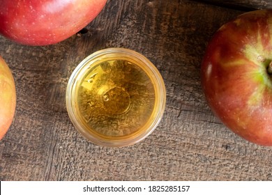 A Bowl Of Apple Cider Vinegar On A Table, Top View