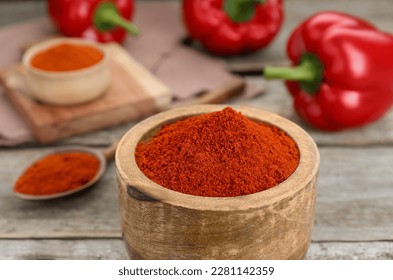 Bowl with aromatic paprika powder on wooden table, closeup - Shutterstock ID 2281142359