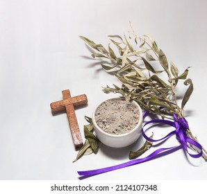 Bowl with ashes, olive branch and cross, symbols of Ash Wednesday