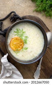 A Bowl Of Avgolemono Greek Chicken Soup On A Wooden Table