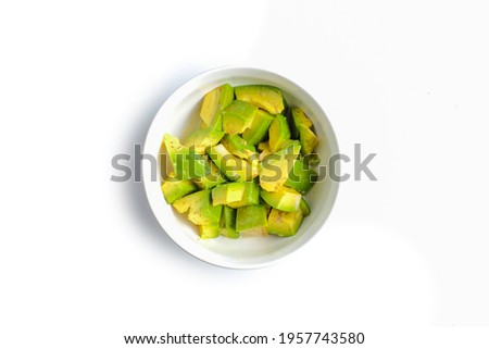 A Bowl of avocado slices isolated on white background