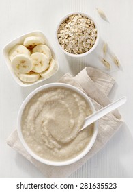 Bowl Of Baby Food, Healthy Breakfast Porridge On White Wooden Table, Top View