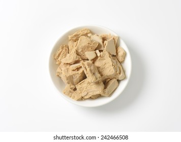 Bowl Of Baker's Yeast On White Background