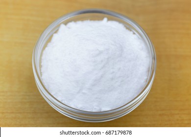 Bowl Of Baking Soda Powder On Wooden Background. It Is Used As Powerful Cleaning Solution
