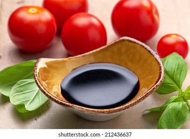 Bowl Of Balsamic Vinegar And Basil Leaves