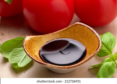 Bowl Of Balsamic Vinegar And Basil Leaves