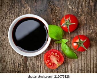 Bowl Of Balsamic Vinegar On Wooden Table