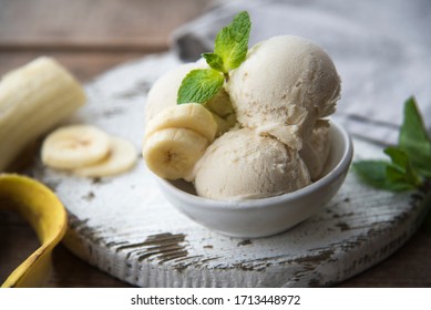 
Bowl Of Banana Ice Cream And Banana On A Wooden Table