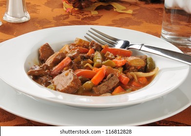 A Bowl Of Beef Pot Roast With Carrots And Green Beans