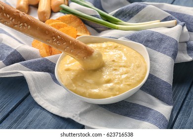 Bowl With Beer Cheese Dip And Bread Stick On Napkin