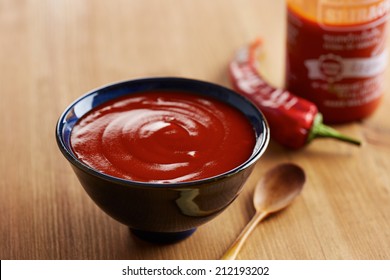 Bowl And Bottle Of Sriracha Sauce