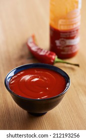 Bowl And Bottle Of Sriracha Sauce