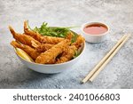 bowl of breaded Torpedo shrimps on painted kitchen table background