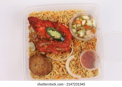 A Bowl Of Briyani Rice With Chicken On White Table