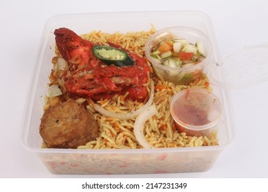 A Bowl Of Briyani Rice With Chicken On White Table