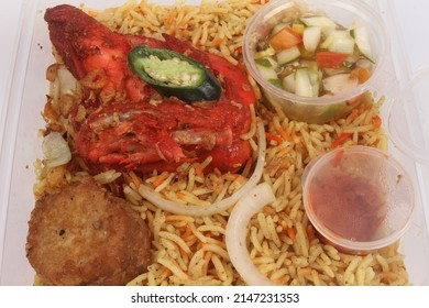 A Bowl Of Briyani Rice With Chicken On White Table