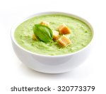 bowl of broccoli and green peas cream soup isolated on white background