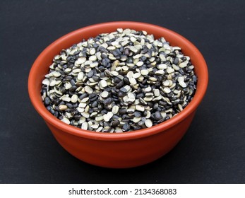 bowl of broken Vigna mungo on black background