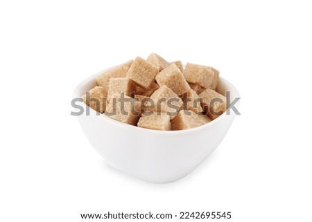 Bowl of brown sugar cubes isolated on white