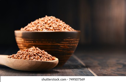 Bowl Of Buckwheat Kasha On Wooden Table.