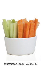 Bowl Of Carrot And Celery Sticks Isolated On A White Background.