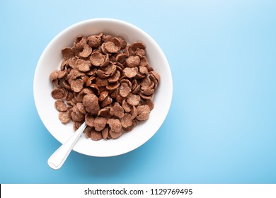 Bowl Of Cereal Chocolate Flavor And Milk With Silver Spoon. Breakfast Top View