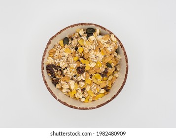 Bowl Of Cereal With Oatmeal And Raisins, Overhead View, White Background.