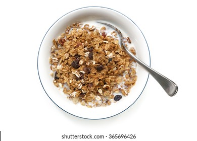 Bowl of cereal with spoon, isolated on white.  Overhead view.