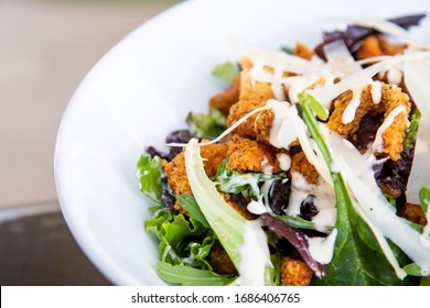 Bowl Of Cesar Salad With Crispy Chicken