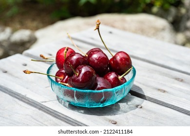 Bowl With Cherries In A Garden