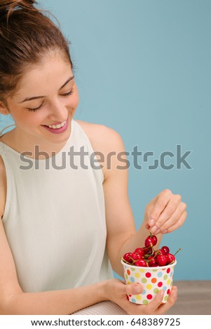 bowl of cherries in women's hands