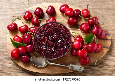 Bowl Of Cherry Jam With Fresh Fruits On A Wooden Table, Top View