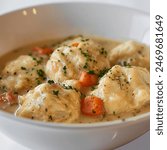 a bowl of chicken and dumplings