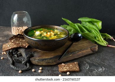 Bowl With Chickpea And Spinach Soup On Dark Table