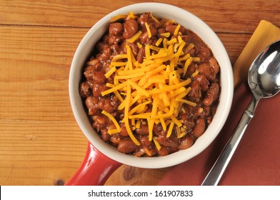 A Bowl Of Chili With Cheddar Cheese Shot From Above