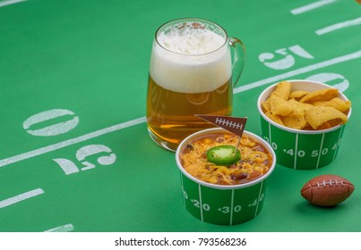 Bowl Of Chili, Chips, And Beer On Table Decorated For Superbowl Party