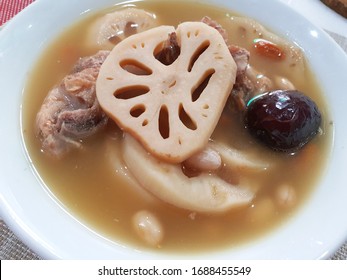 Bowl Of Chinese Traditional Pork Rib Soup With Lotus Root, Peanut And Red Dates.