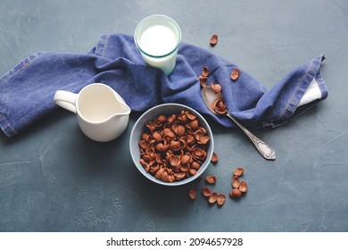 Bowl With Chocolate Cornflakes And Jug Of Milk On Dark Background