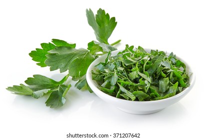 Bowl Of Chopped Parsley Leaves Isolated On White Background