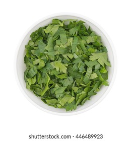 Bowl Of Chopped Parsley Leaves Isolated On White Background