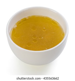 A Bowl Of Clear Chicken Broth On A White Background